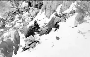  ?? THE ASSOCIATED PRESS ?? The blanket-wrapped body of Carole Lombard is removed from the wreckage of a Los Angeles-bound TWA plane on Potosi Mountain near Las Vegas on Jan. 18, 1942.