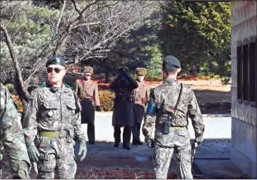  ?? AFP ?? North Korean soldiers stare at South Korean soldiers at the truce village of Panmunjom in the Demilitari­sed Zone dividing the two Koreas on November 27.