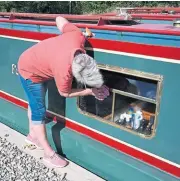  ?? ?? Cath Preedy takes care of last-minute window cleaning alongside the wharf.