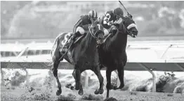  ?? BENOIT PHOTO ?? Maximum Security (left) with Abel Cedillo aboard, overpowers Midcourt and jockey Victor Espinoza to win Saturday’s Grade II, $150,000 San Diego Handicap.