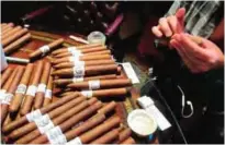  ??  ?? Photo show cigars being hand-rolled at Jimenez Tobacco, which operates a cigar lounge and bar in Newark, NJ.