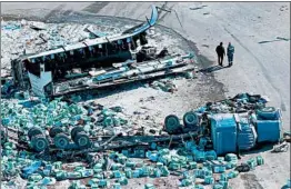  ?? JONATHAN HAYWARD/THE CANADIAN PRESS ?? The force of the impact appears to show the bus ripped in two, top, the tractor-trailer and scattered debris Saturday near Tisdale, Saskatchew­an. The crash happened Friday.