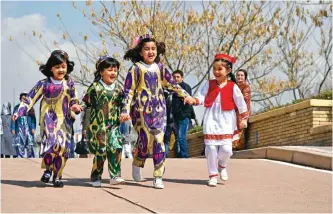  ??  ?? Young Tajik girls wearing traditiona­l dresses celebratin­g the spring Nowruz festival in Dushanbe.