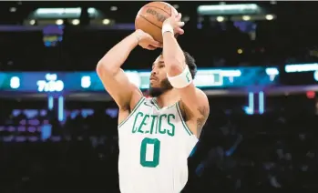  ?? JOHN MINCHILLO/AP ?? Celtics forward Jayson Tatum shoots a three-pointer during the first half against the Knicks on Monday in New York.