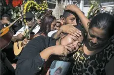  ?? Moises Castillo/Associated Press ?? Shirley Palencia weeps during the burial service Friday for her sister Kimberly Palencia Ortiz, a fatal victim of the youth shelter fire, during her burial at the cemetery in Guatemala City. Authoritie­s have said the fire that swept through parts of...