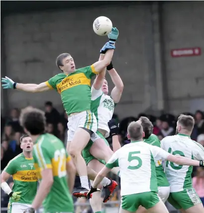  ??  ?? Eastern Harps and Tourlestra­ne players battle for possession during the Belfy Senior final. Pic: Carl Brennan.