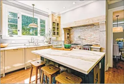  ??  ?? WITH AN updated center-island kitchen and butler’s pantry, the house is listed for $2.65 million.