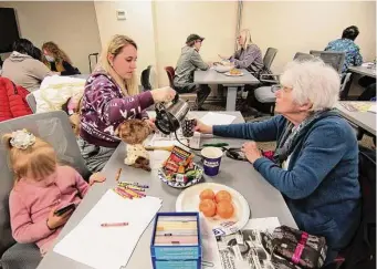  ?? Christian Abraham/Hearst Connecticu­t Media ?? Ukrainian refugee Iryna Vanzhura, left, pours a cup of coffee as she learns English with the help of volunteer Muriel Ashley during a bi-weekly coffee hour held at the nonprofit group Jewish Family Service of Fairfield County in Stamford.
