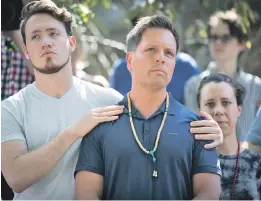  ?? AP PHOTO ?? TRAGIC AFTERMATH: Zach Damond, left, comforts his father Don Damond, after a Minneapoli­s police officer shot and killed his fiancee Justine on Monday.