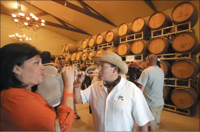  ?? JIM STEVENS — STAFF FILE PHOTO ?? Monica and Anthony Proctor, of Brentwood, sample chardonnay in the barrrel room at the annual Hannah Nicole Winery barrel-tasting event in Brentwood in 2013.