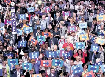  ?? WIN McNAMEE/GETTY IMAGES ?? Delegates hold up signs in support of Democratic presidenti­al nominee Hillary Clinton on the fourth day of the Democratic National Convention at the Wells Fargo Center on Thursday in Philadelph­ia, Penn.