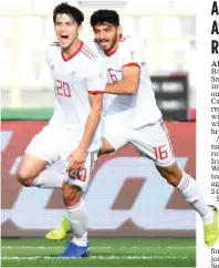  ?? — AFP ?? Iran’s Sardar Azmoun (left) celebrates after scoring against Vietnam in their Asian Cup Group D match at the Al-Nahyan Stadium in Abu Dhabi on Saturday.