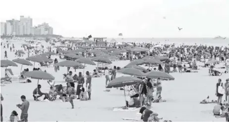  ?? Associated Press file ?? When fellow employees are at the beach, it could be a good time to fill in at another job or join a company team.