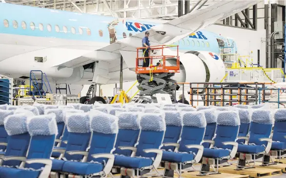  ?? RYAN REMIORZ/THE CANADIAN PRESS ?? A Bombardier employee works on a CSeries 300 jet Thursday. The company is accused of breaking trade rules by receiving substantia­l subsidies.