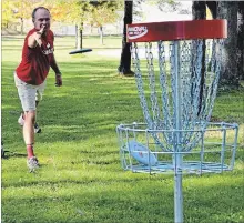  ?? CATHERINE WHITNALL KAWARTHA LAKES THIS WEEK ?? Avid disc golf player and course developer Darrell Bankes tests out one of the holes at the recently completed course in Memorial Park in Lindsay. The nine-hole course is open year round and free to use.