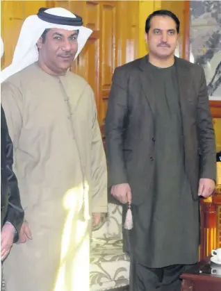  ?? EPA ?? Juma Al Kaabi, left, UAE Ambassador to Afghanista­n, with Dr Hamayoun Azizi at a ceremony in Kandahar, on January 10. That day two bombs killed Al Kaabi and 12 others, and badly wounded Dr Azizi.