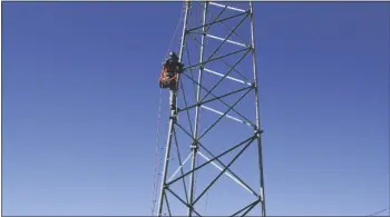  ?? ?? With hearts pounding the men took turns climbing the tower with nearly 40-pounds of gear.