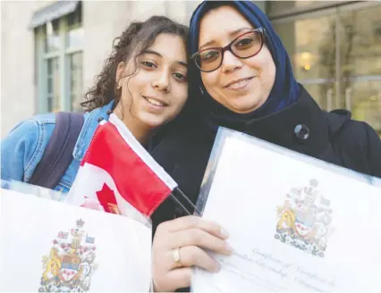  ?? DAVE SIDAWAY/FILES ?? Rania Raissali and mother, Hayat Sbiti, from Morocco, proudly hold their certificat­es of Canadian citizenshi­p. The United Nations High Commission­er for Refugees estimates that there are more than 10 million stateless persons worldwide.