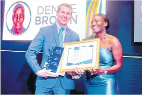  ??  ?? SRI Winner: Denise Brown, Sandals Resorts Internatio­nal’s Diamond Team Member of the Year and the company’s group shipping clerk, is presented with the winning trophy and prizes by the company’s Deputy Chairman, Adam Stewart, at the recently held Annual Prestige Awards Ceremony.