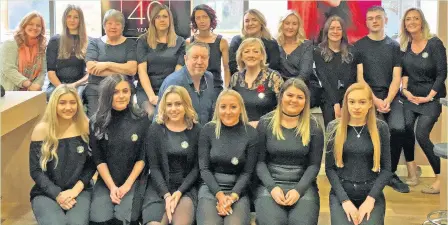  ??  ?? Pictured (centre) are Andrew and Jo Smith with members of employees at Smith and Smith Hair.
