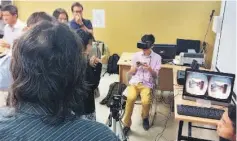  ??  ?? A visitor (seated) trying out the VR headset.