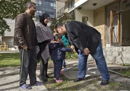  ?? LUCAS OLENIUK/TORONTO STAR ?? Khaled Alawad, left, and his family meet Alex Haditaghi. Haditaghi offered the Alawads, who lost everything in a fire, a free apartment for a year.