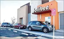  ??  ?? LEFT: Cars wait for orders in the drive-thru of Jollibee last week. RIGHT: order from the Jollibee drive-thru window.