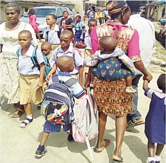  ??  ?? Parents taking their children out of school in Port Harcourt… yesterday. PHOTO: NAN