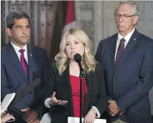  ?? JUSTIN TANG, THE CANADIAN PRESS ?? Immigratio­n critic Michelle Rempel is flanked by fellow Conservati­ve MPs Pierre Paul-Hus, left, and Larry Maguire as she speaks to reporters Monday in Ottawa.