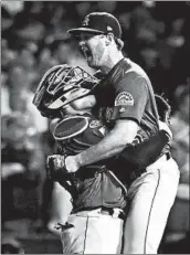  ?? NUCCIO DINUZZO/CHICAGO TRIBUNE ?? Rockies catcher Tony Wolters, who had the game-winning hit in the 13th inning, celebrates with reliever Scott Oberg.