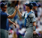  ?? AP PHOTO BY DAVID ZALUBOWSKI ?? Los Angeles Dodgers’ Enrique Hernandez, left, congratula­tes catcher Will Smith after a baseball game against the Colorado Rockies on Wednesday, July 31, in Denver. The Dodgers won 5-1.