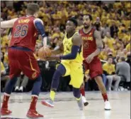  ?? DARRON CUMMINGS — THE ASSOCIATED PRESS ?? Pacers’ Victor Oladipo (4) heads to the basket as Cavaliers’ Kyle Korver (26) and JR Smith (5) defend during the second half of Game 6 of a first-round series on Friday.