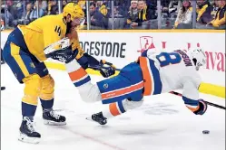  ?? USA TODAY Sports ?? PREY FOR THEM: Islanders defenseman Noah Dobson takes a hit from Predators defenseman Mattias Ekholm during the second period Thursday at Bridgeston­e Arena.