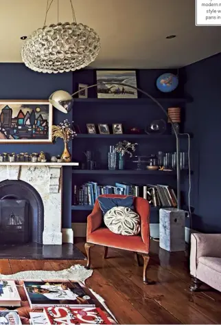  ??  ?? The living room is painted Hague Blue by Farrow & Ball; modern meets country style with hanging pans in the kitchen