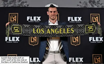  ?? ?? Gareth Bale holds aloft an LAFC scarf at his new club at the Banc of California Stadium