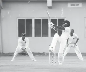  ??  ?? Kharry Pierre hooks during his 89-ball 30 (Orlando Charles photo