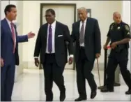  ?? ASSOCIATED PRESS ?? Lawyer Fortunato N. Perri Jr., left, waits for Andrew Wyatt, second from left, to guide Bill Cosby back to the courtroom after lunch during Cosby’s sexual assault trial inside the Montgomery County Courthouse in Norristown on Monday.