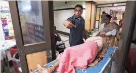  ?? AP PHOTO ?? Amarjeet Singh, one of the 20 bouncers now on staff at Deen Dayal Upadhyay Hospital, helps a patient on a stretcher.