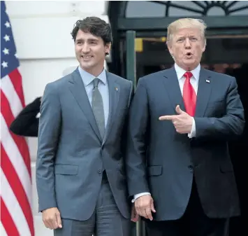  ?? SEAN KILPATRICK/THE CANADIAN PRESS ?? U.S. President Donald Trump with Prime Minister Justin Trudeau as he welcomes him to the White House on Wednesday.