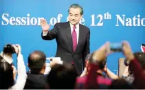  ??  ?? Chinese Foreign Minister Wang Yi waves as he leaves following a press conference held on the sideline of the National People’s Congress at the media center in Beijing on Wednesday. (AP)
