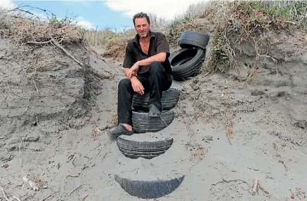  ?? PHOTOS: ADAM POULOPOULO­S ?? Michael Eisenhofer on the tyre path he created over the dune to Peka Peka Beach. Below: A makeshift trail down the sand dune at Peka Peka Beach.