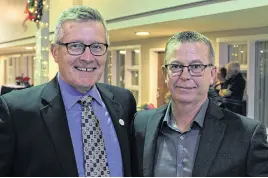  ?? GRANT HARRISON • SPECIAL TO THE GUARDIAN ?? Curlers and former teammates Peter Gallant, left, and Robert Campbell catch up with each other after their induction ceremony into the P.E.I. Sports Hall of Fame in Charlottet­own Nov. 25.