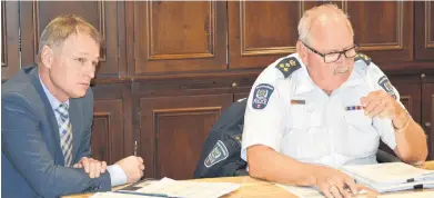  ?? DAVE STEWART/THE GUARDIAN ?? Charlottet­own Police Services Chief Paul Smith, right, says the proposed bylaw amendment around beehives is designed to prevent crates of them from being located in residentia­l neighbourh­oods. The issue came up again at a recent protective and emergency services meeting. Also pictured is Deputy Police Chief Brad MacConnell.
