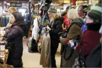  ?? STEPHANIE ZOLLSHAN — THE BERKSHIRE EAGLE VIA AP, FILE ?? In this file photo shoppers form a long line at checkout during Small Business Saturday at the Arcadian Shop in Lenox, Mass.