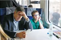  ??  ?? Former Georgian President Mikheil Saakashvil­i and his son Nikoloz sit in a train at a railway station in Przemysl, Poland, on Sunday. (Reurers)