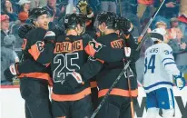  ?? MITCHELL LEFF/GETTY ?? The Flyers’ Travis Sanheim, left, celebrates with Ryan Poehling and Garnet Hathaway after scoring a goal against the Maple Leafs in the second period at the Wells Fargo Center on March 19 in Philadelph­ia.
