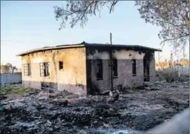  ?? ?? In ruins: A house used by artisanal miners, who are on the lowest rung of the illegal mining heirarchy, was burnt by West Rand residents