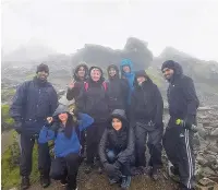  ??  ?? ●●Staff from the Wellfield pharmacy who scaled Mount Snowdon for Dementia UK