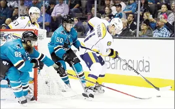  ??  ?? Nashville Predators’ Cody Hodgson (right), moves the puck away from San Jose Sharks’ Brent Burns (88) and Chris
Tierney (50) during the second period of an NHL hockey game on Oct 28, in San Jose, California. (AP)