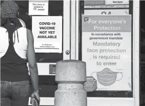  ?? ASHLEY LANDIS/AP ?? A COVID-19 sign greets a resident in Long Beach, Calif., part of an area of the state that has been slammed by coronaviru­s infections since the Thanksgivi­ng break.